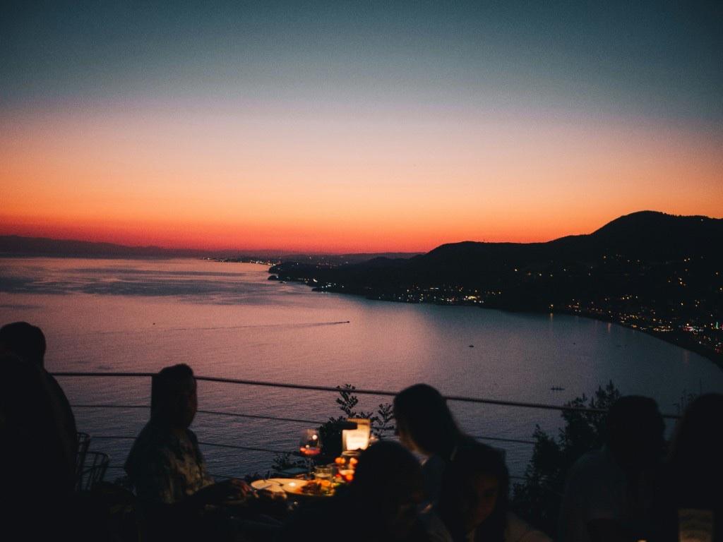 Sunset over a coastal dining terrace
