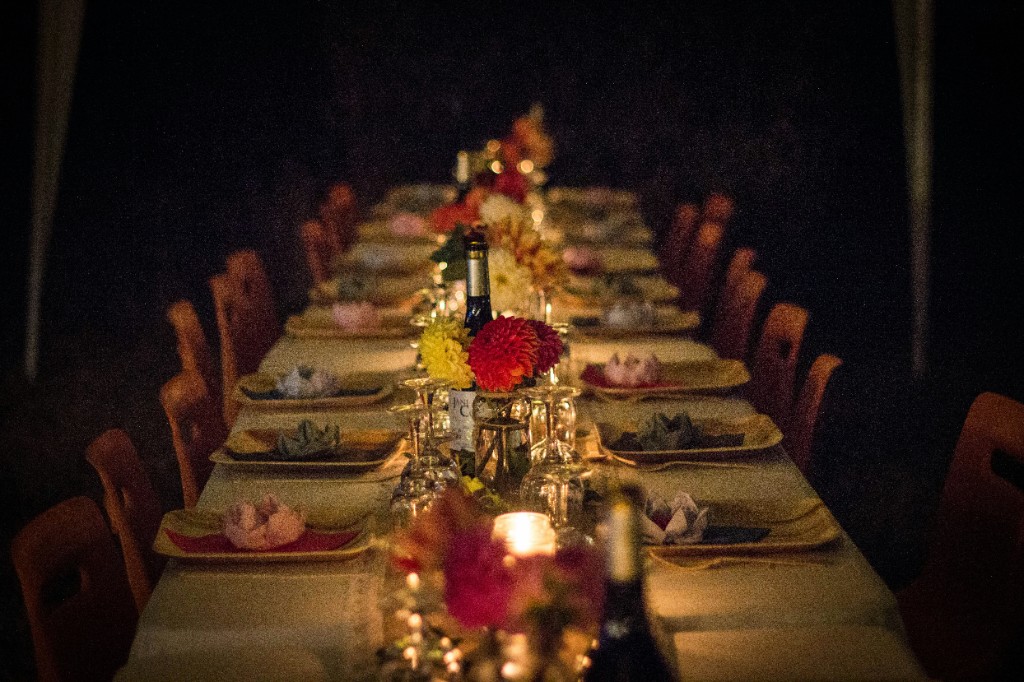 Candlelit banquet table set with flowers and wine glasses